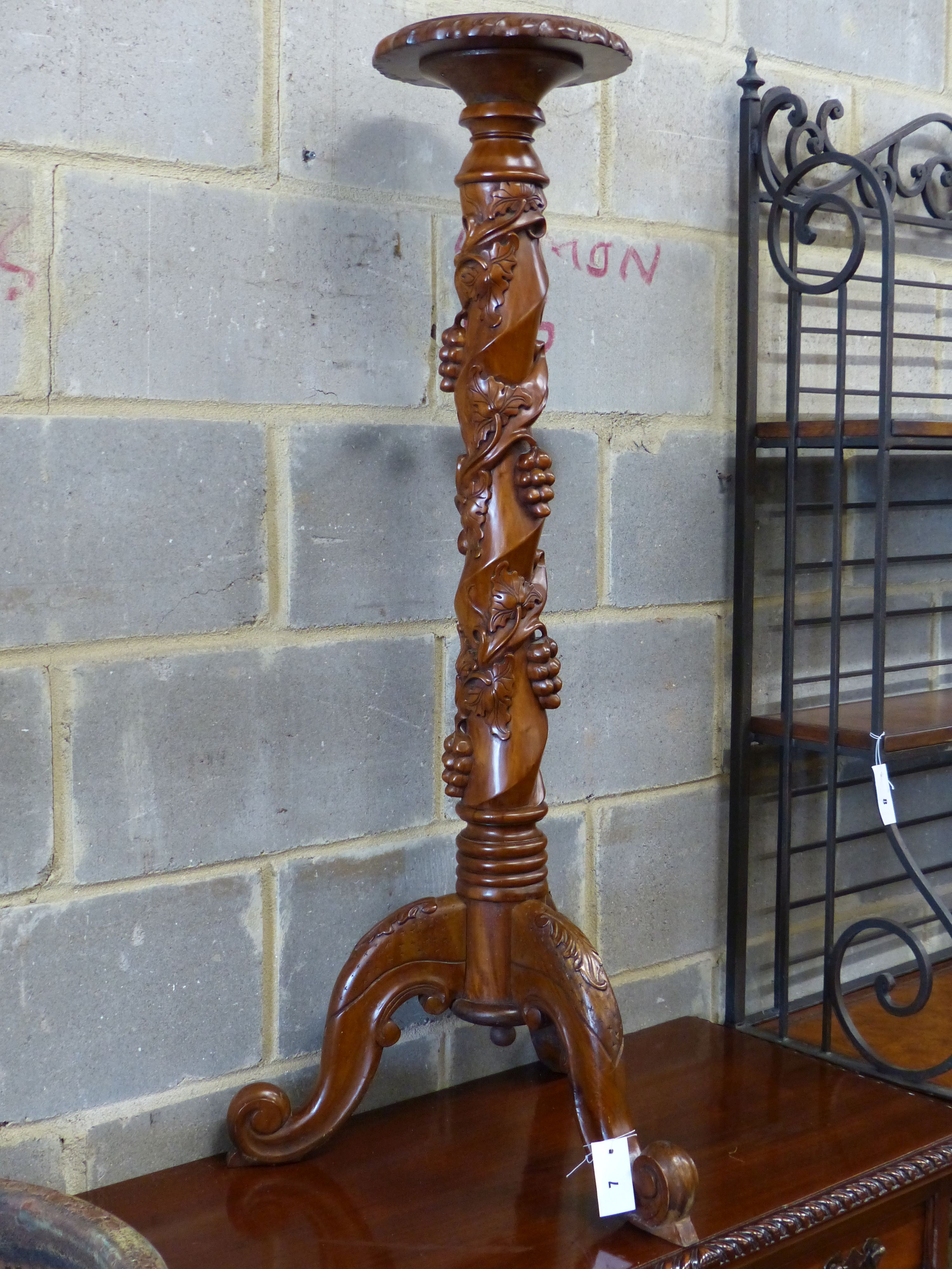 A reproduction carved mahogany torchere, height 114cm